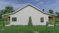 a small white building sitting on top of a lush green field