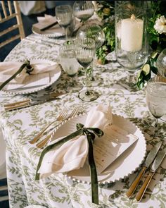 the table is set with place settings and silverware