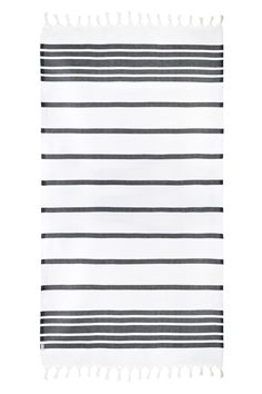 a black and white striped rug with tassels