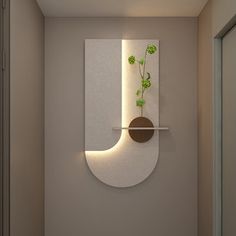 a wall mounted planter on the side of a white wall next to a door