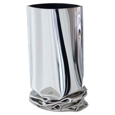 a silver vase with black lines on it