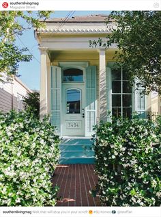 the front door of a house with blue shutters