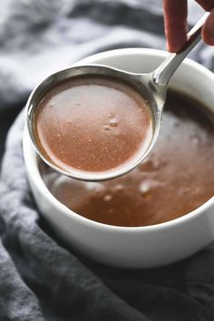 a spoon in a bowl filled with liquid