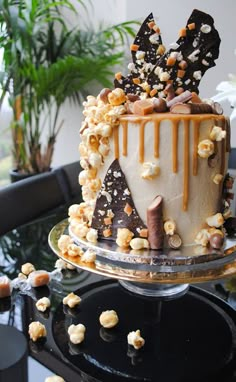 a cake is decorated with chocolate, caramel and popcorn