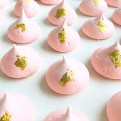 some pink and gold desserts on a table