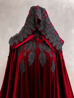 a red cape with grey lace on it