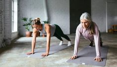 two women doing push ups on yoga mats