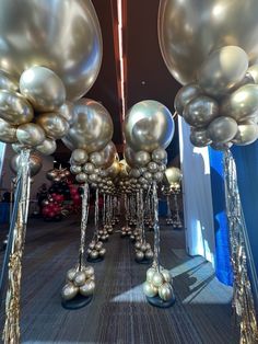 silver balloons are hanging down from the ceiling