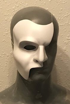 New from Studio D FX is a Phantom of the Opera half-mask inspired by the original Toronto production and the iconic look by musical theatre legend Colm Wilkinson. Many reference photos from the production were used during the sculpting of the one-of-a-kind piece. The mask is made of thermoformed plastic (just as in the show) and is airbrushed to match the highlights and shading of the stage mask. A wire is included for wear. It is attached using durable tape so the wearer can adjust the wire to The Phantom Of The Opera Mask, Phantom Of The Opera Cosplay, Anthony Warlow, Phantom Of The Opera Mask, Dracula Cape, Phantom Mask, Sketchbook Ideas Inspiration, Theatre Ideas, Cardboard Costume