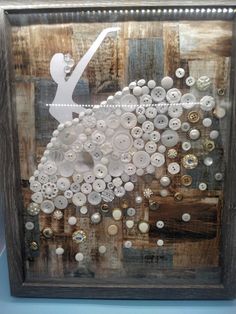 a wooden frame with buttons on it in the shape of a sheep and a bird