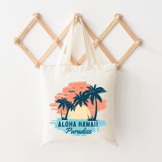 Looking for a cute tote bag to carry all your essentials this summer? This cute Aloha Hawaii bag will be perfect to add to your collection. Perfect for a day at the beach or every day life! Summer Beach Season Gift Bag, Summer Beach Season Gift Bags, Tropical Bags For Everyday Beach Use, White Tropical Travel Bag, Cute Rectangular Beach Bag For Travel, White Tropical Style Travel Bags, Cute White Beach Bags, Casual Beach Bag For Beach Season Gift, Cute White Bag For The Beach