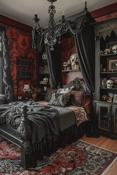 a bedroom decorated in black and red with skulls on the bed, chandelier