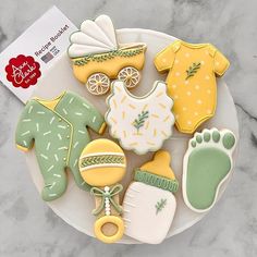 baby shower cookies are arranged on a plate