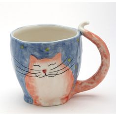 a ceramic mug with a cat painted on it