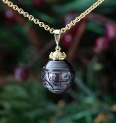 This hand-carved Tahitian Black Pearl Pendant is a truly unique work of art! Each black pearl is individually hand-carved by Tahitian artisans with Polynesian designs with no two being the same. The setting has then been crafted in granulated 18K Treasure Gold made with actual shipwreck treasure. Treat yourself to a true island treasure! (Chain Not Included) Featuring a 13.8mm black pearl that has been hand-carved by Tahitian artisans, this pendant has been handcrafted in granulated 18K Treasure Traditional Black Etched Jewelry, Elegant Black Ceremonial Necklace, Traditional Carved Necklaces For Formal Occasions, Artisan Black Carved Jewelry, Treasure Gold, Black Pearl Jewelry, Black Pearl Pendant, Tahitian Pearls Jewelry, Polynesian Designs