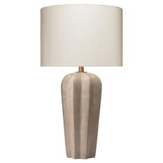 a lamp that is on top of a table with a white lampshade next to it