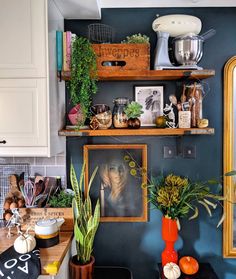 the kitchen is decorated with plants and pictures