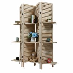 a wooden room divider with shelves and vases on top of each shelf next to a teddy bear