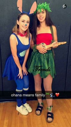 two girls dressed up in costumes posing for the camera with their hands on their hips