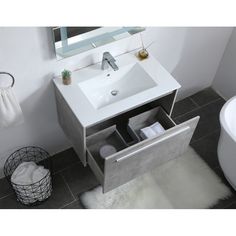 a white sink sitting under a mirror next to a bath tub