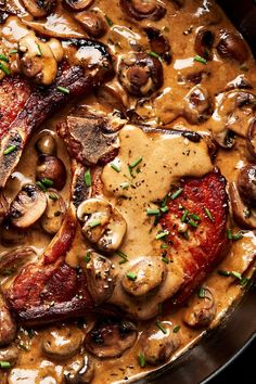 a pan filled with meat and mushrooms covered in gravy