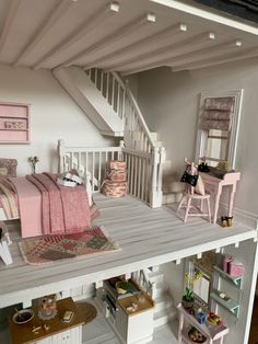 a doll house is shown with furniture and accessories on the floor in front of stairs