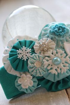 a close up of a headband with flowers and snowflakes on top of it