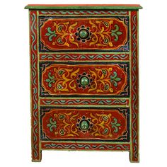 an ornately painted chest of drawers with two drawers on one side and three drawers on the other