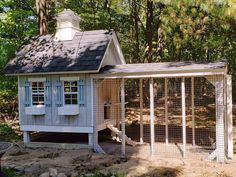 a chicken coop in the middle of a wooded area