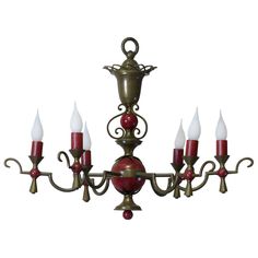 a chandelier with five red candles on it