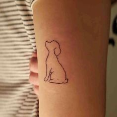 a small dog tattoo on the right forearm and wrist, with a silhouette of a dog sitting down