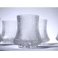 three clear glass vases sitting next to each other