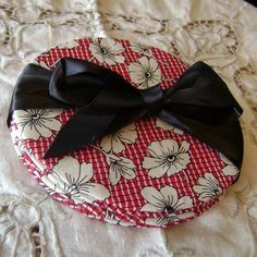 a red and white plate with a black bow on it