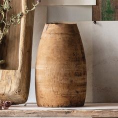 two wooden vases sitting next to each other on a shelf