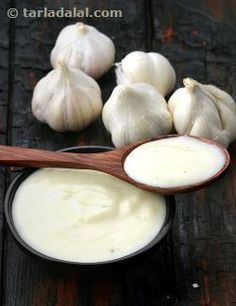 garlic and cream in a bowl on a wooden table