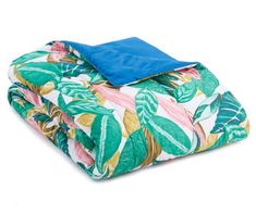 an image of a bed set with tropical print and blue comforter on white background