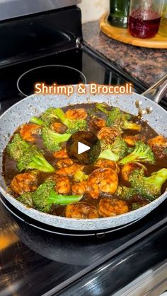 shrimp and broccoli cooking in a skillet on top of an electric stove