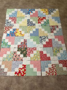 a patchwork quilt is laying on the floor