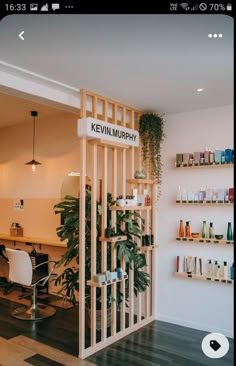 the interior of a salon with shelves and plants