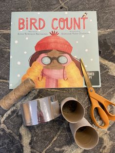 the bird count book is next to some scissors