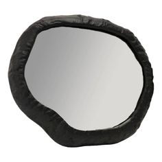 a mirror that is made out of black leather and has an oval shape on it