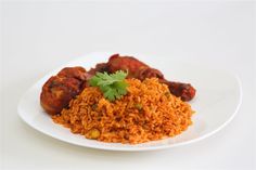 a white plate topped with rice and meat covered in cilantro sauce on top of a white table