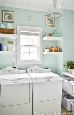 a white washer and dryer sitting next to each other in a laundry room