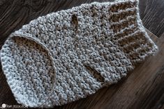 a crocheted hat sitting on top of a wooden floor