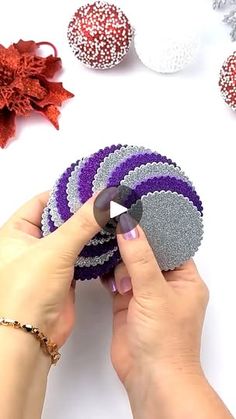 someone is making some decorative balls out of felt