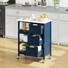 a kitchen island cart with three drawers on wheels