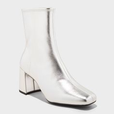 Stay on-trend during cool-weather outings with these Pippa Chunky Heel Ankle Boots from A New Day™. These silver ankle boots are designed with a D-toe with 2.75in block heel for a stunning look. They boast a cushioned insole and breathable upper to add that extra layer of comfort to your step, while the side zipper closure makes for easy on and off. Pair them with a variety of dresses, skirts and jeans for effortless style on casual outings. A New Day™: Style that goes wherever you do. Silver Boots Low Heel, Winter Silver Boots With Reinforced Heel, Silver Leather Ankle Boot Heels, Silver Boots For Fall, Medium Width, Silver Ankle-high Heeled Leather Boots, Silver Ankle Boots, Heel Stretch, Chunky Heel Ankle Boots, Rubber Boot