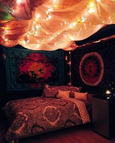 a bed room with a neatly made bed and lots of lights on the wall above it