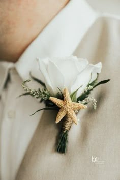 a close up of a person wearing a boutonniere with a starfish on it