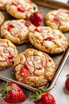 strawberry shortbread cookies on a baking sheet with fresh strawberries